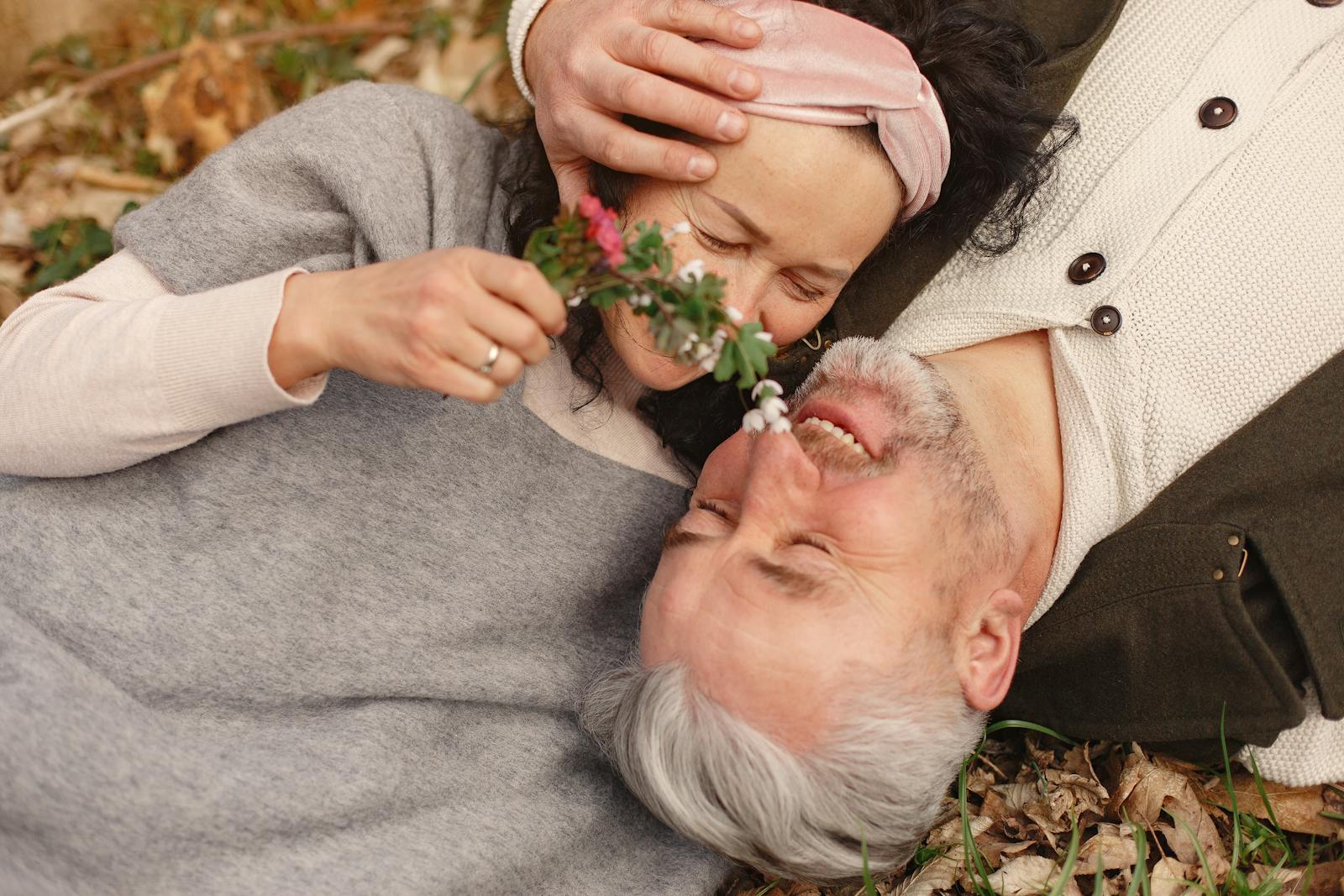 senior couple in love lying in nature with flowers reflecting on what matters most