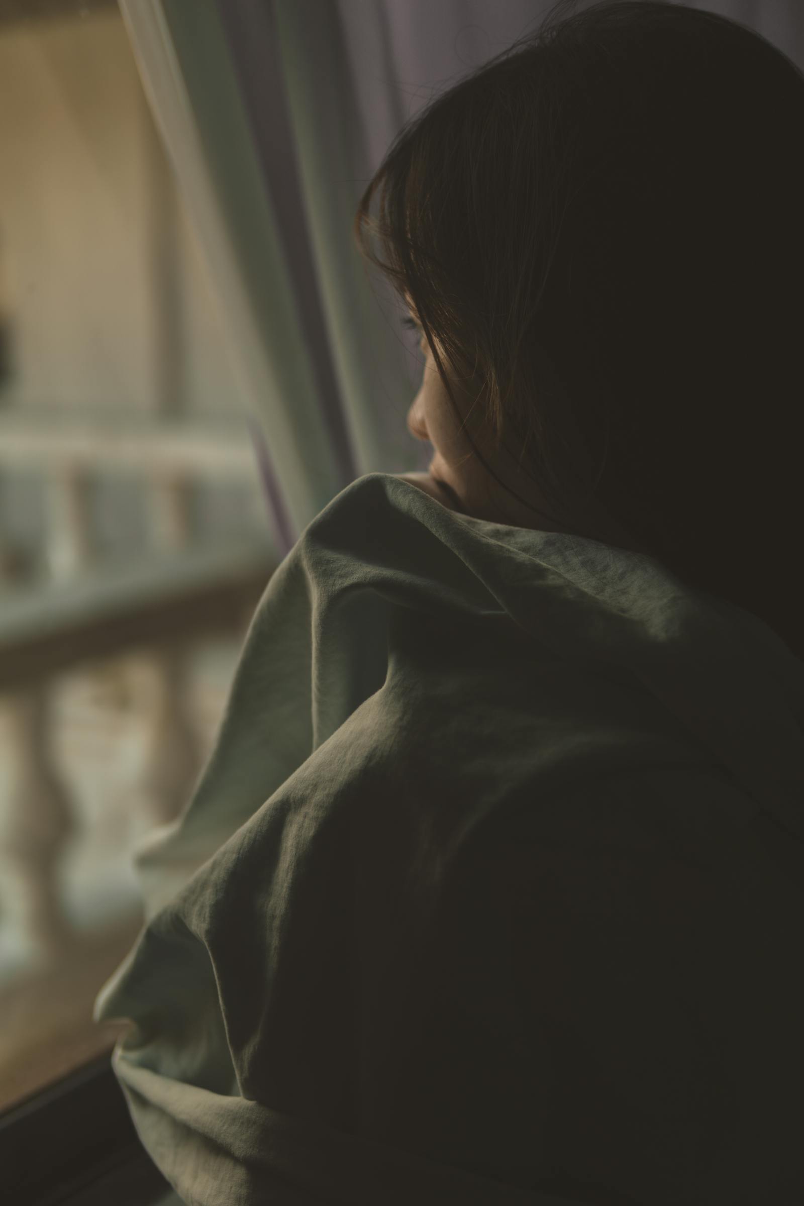 A scared child sitting alone, representing the impact of childhood neglect