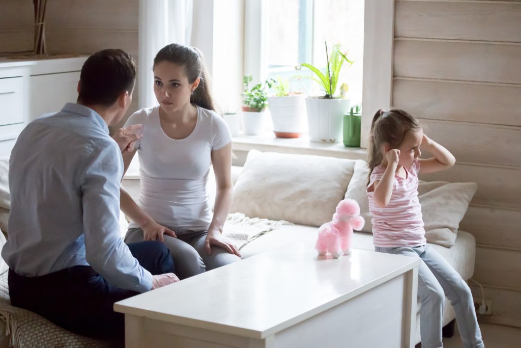 Couple arguing with toddler next to the adults. Childhood Emotional Neglect Influences Adult Attachment Styles