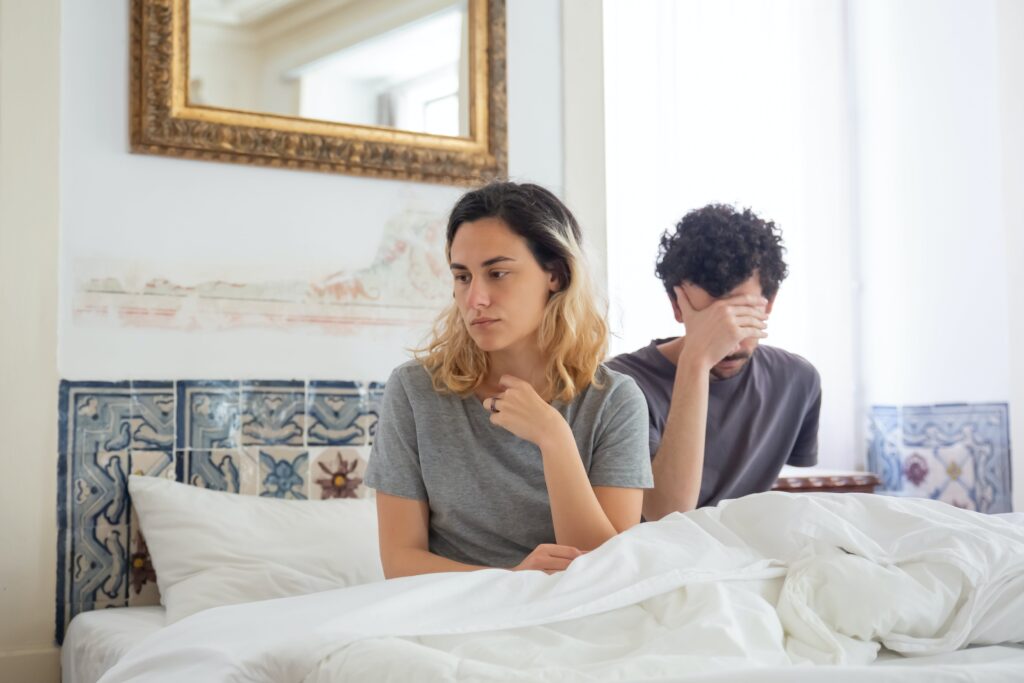 Couple on the bed ignoring each other and how to avoid it