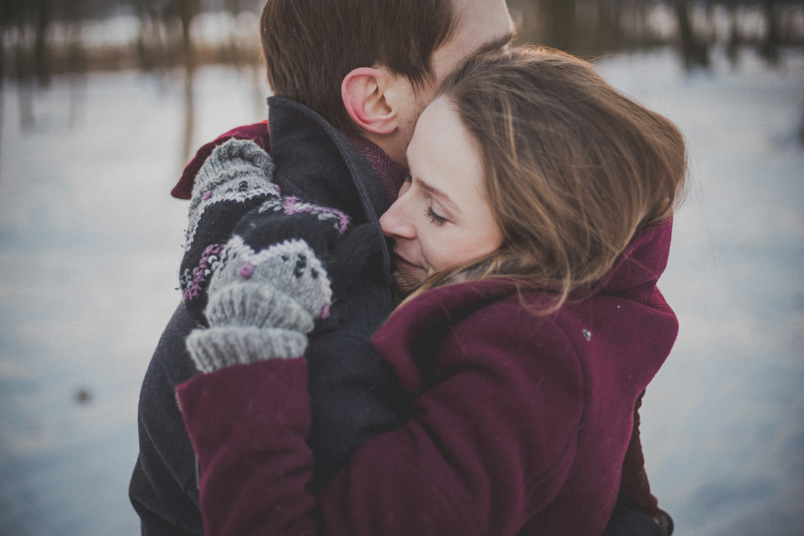 Couple hugging each other outdoors in a snowy day. Bring it Back to Life