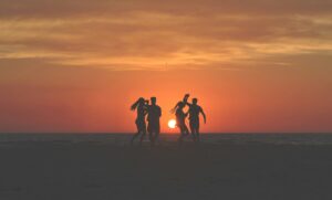 Two couples dancing at a beach in front of a sunset. It’s really not that hard.