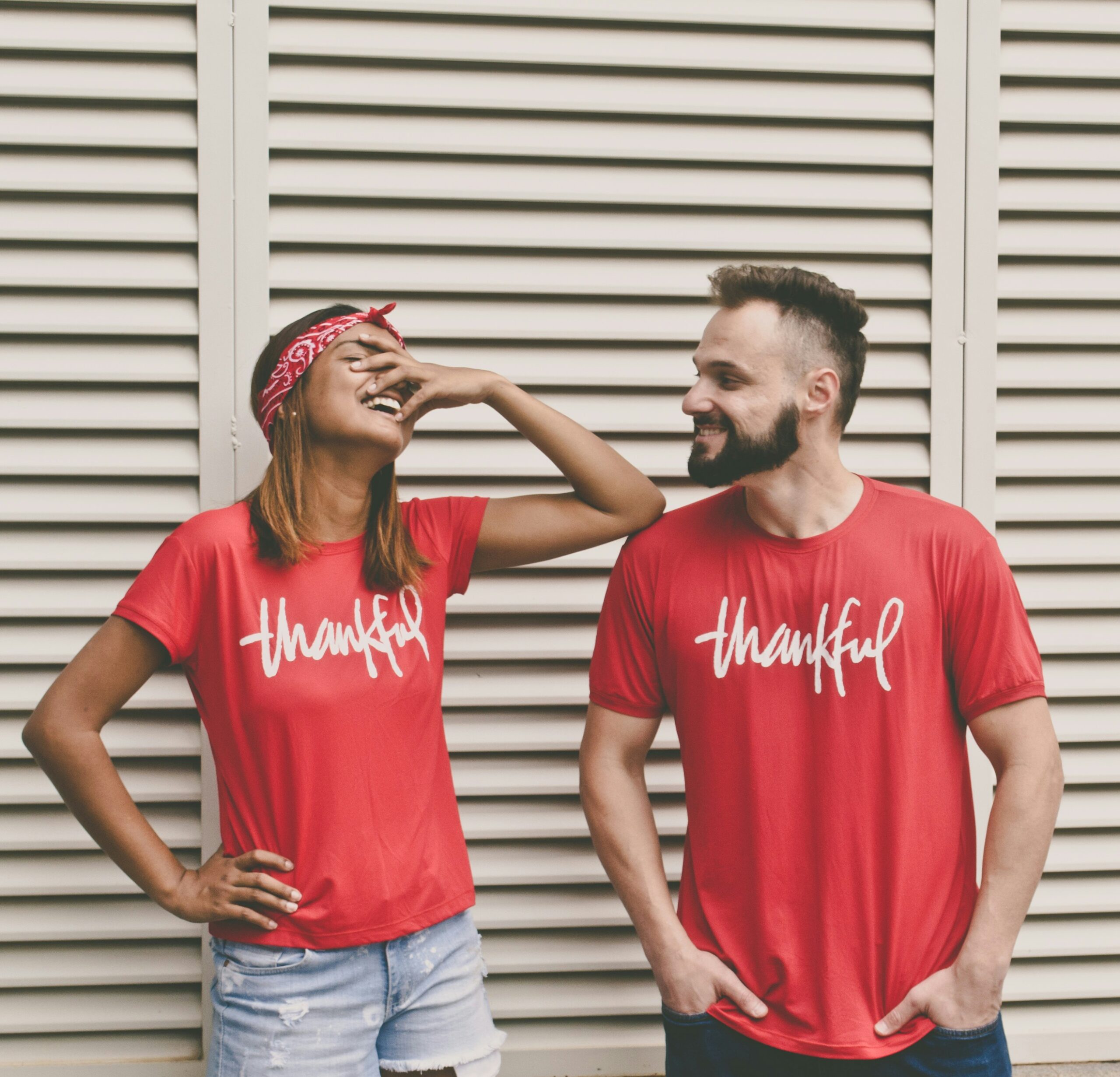 woman and man standing next to each other, both wearing a red t-shirt with printed word "thankful", reflections on Canadian Thanksgiving Day