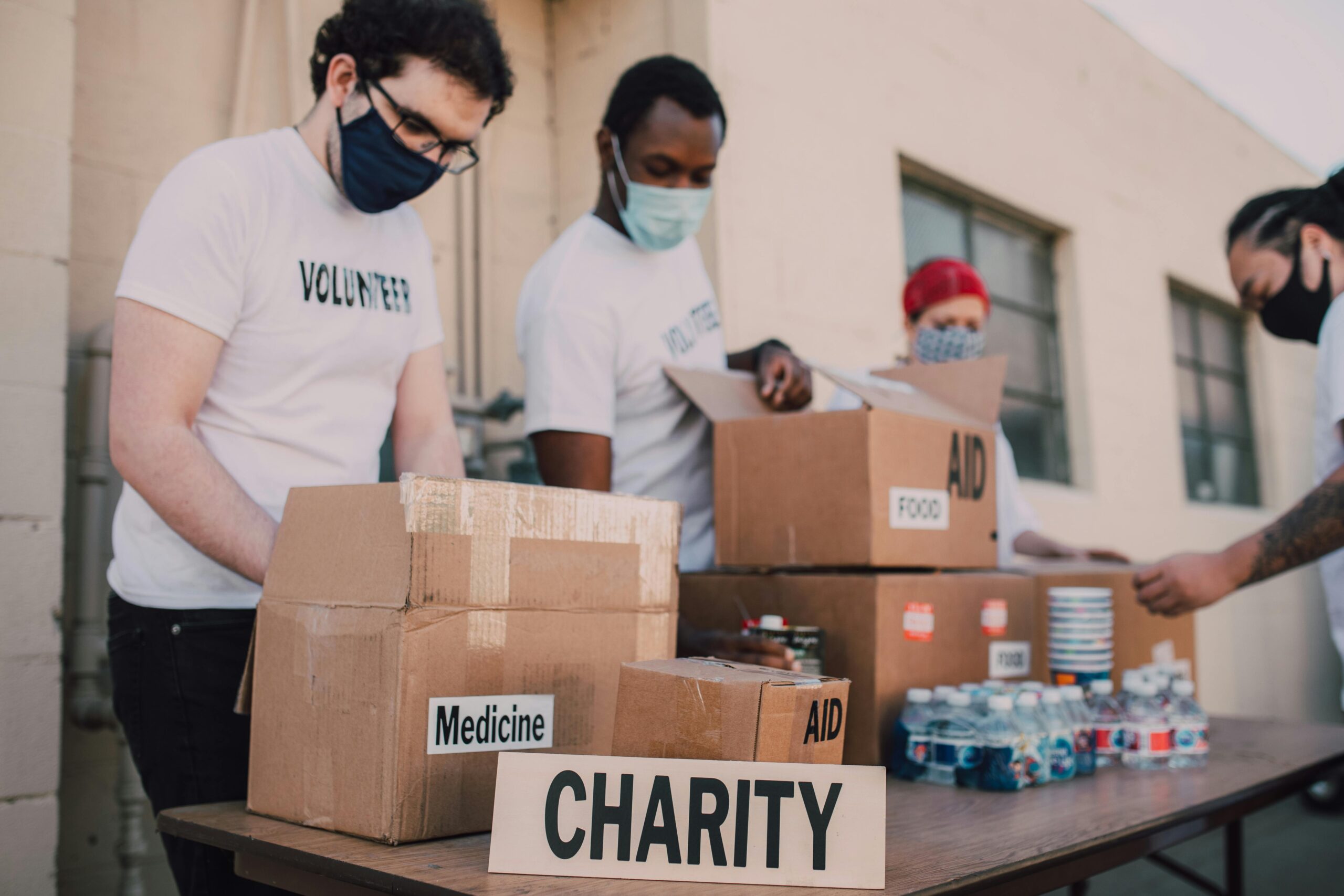 Group of volunteers with a table set up of boxes of donations for charity. The Hidden Gift in LA's Devastating Fires.