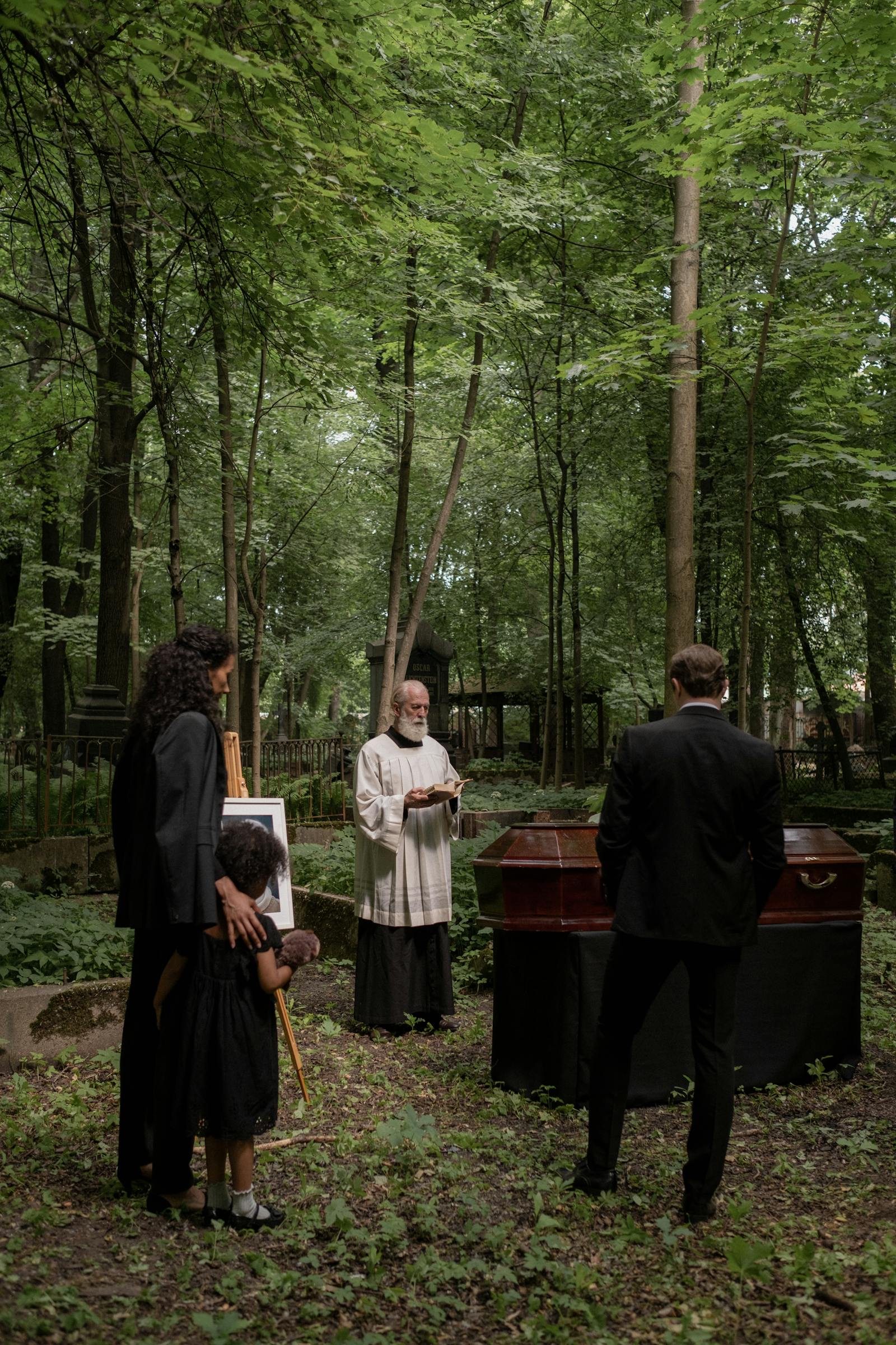 People grieving at cemetery memorial