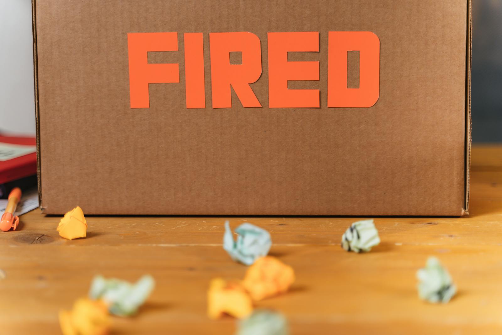 Cardboard sign with text Fired written on it