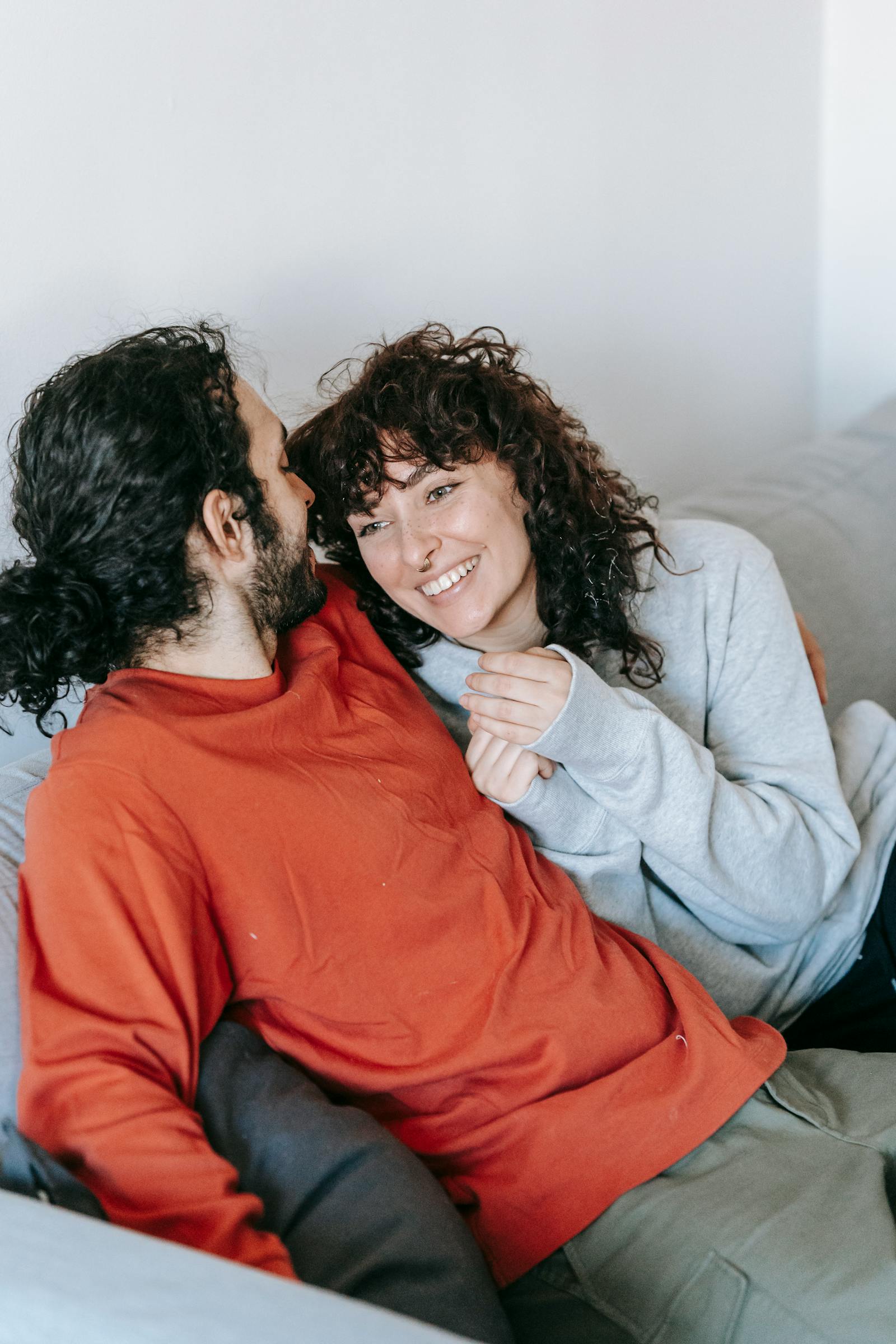 happy couple sitting on couch together celebrating championship relationship secrets