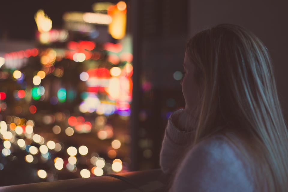 A woman sitting thoughtfully by a window